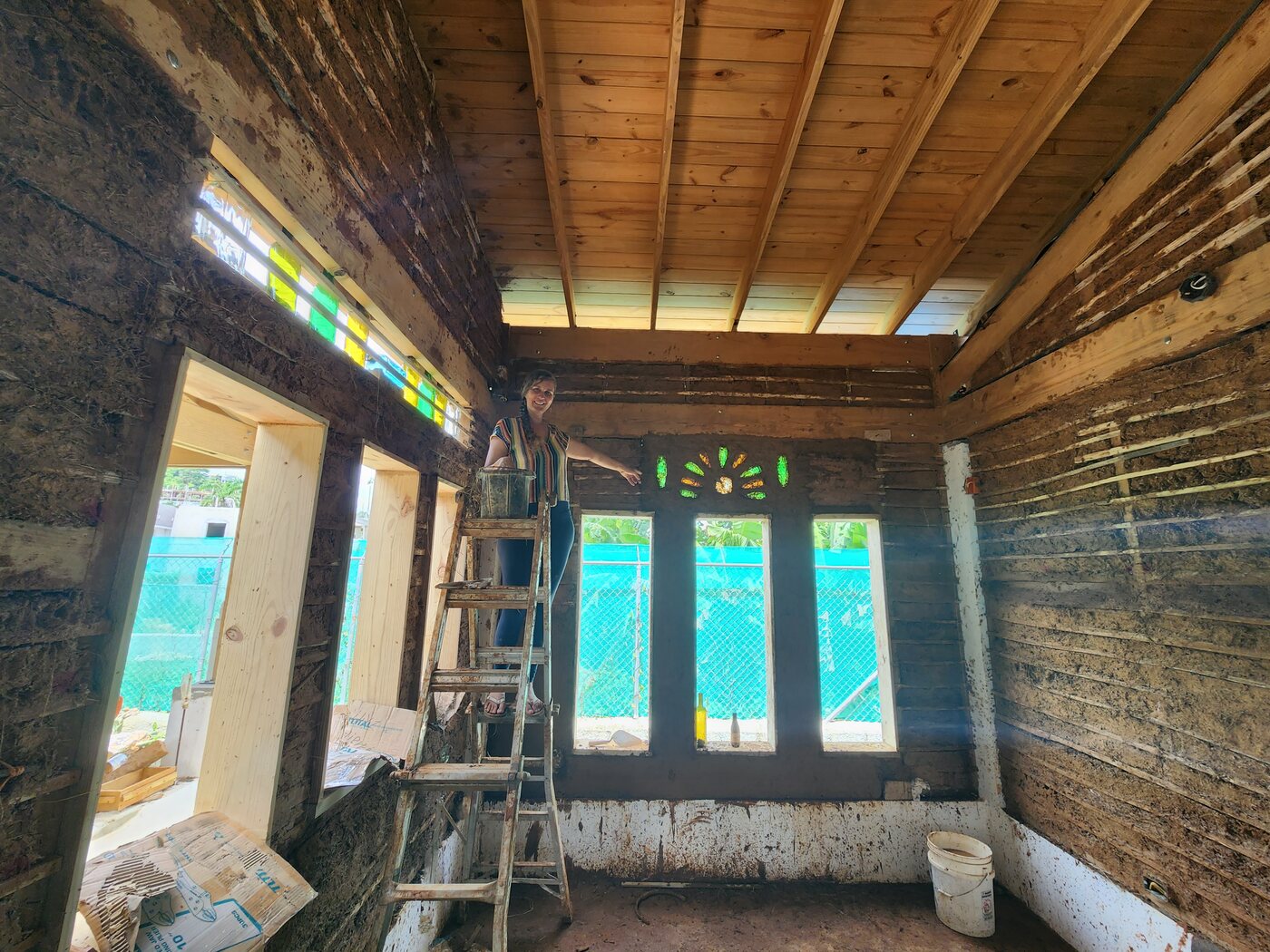 Interior con dos motivos de sol de botellas y persona en escalera